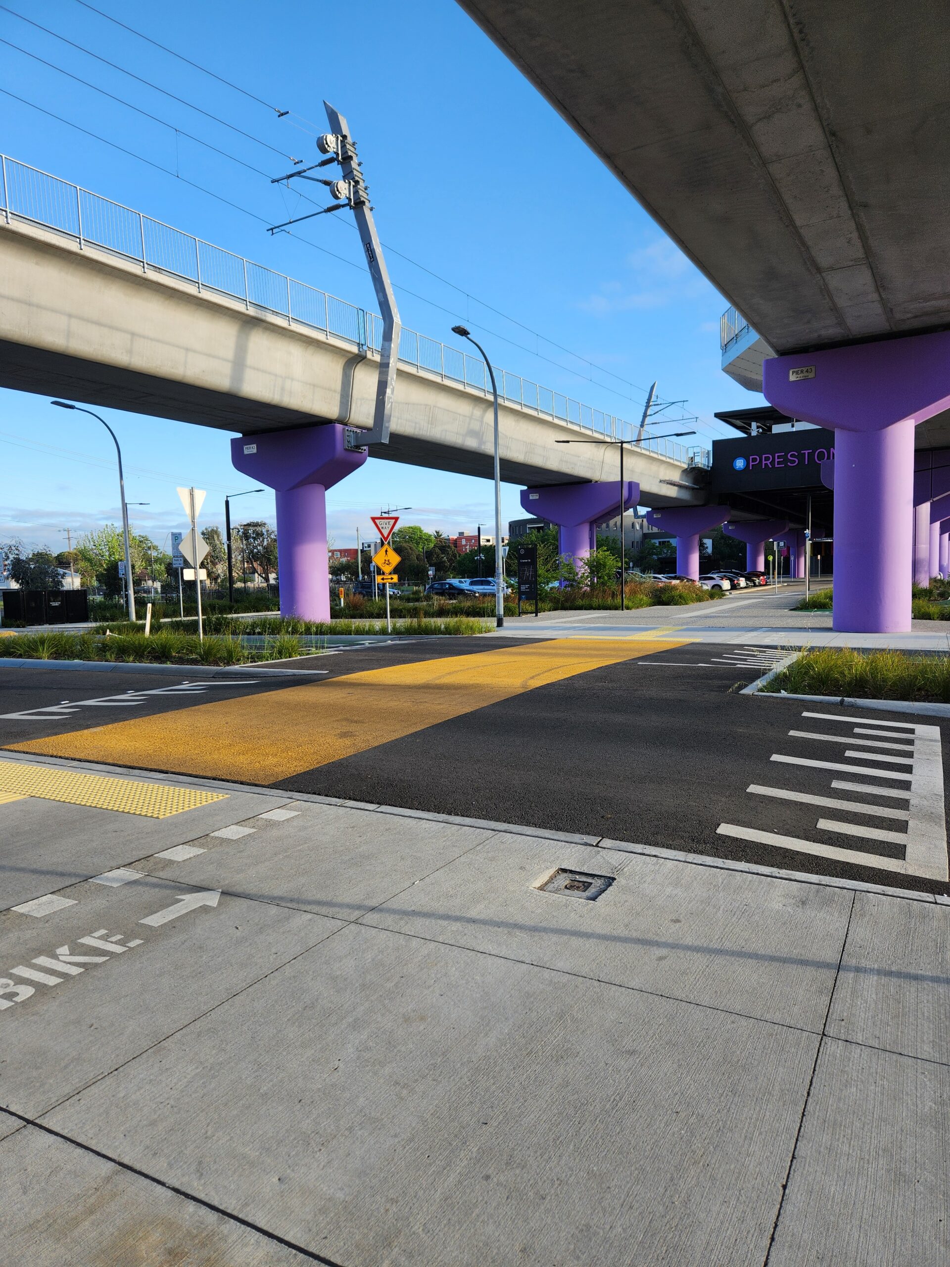 Image of a road with a yellow crossing and give way sign